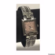 wristwatch with a silver-toned metal band and a square face